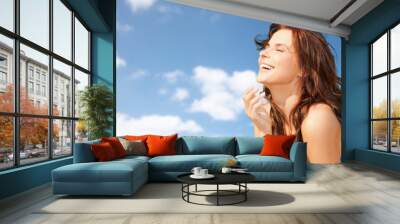 happy beautiful woman over blue sky and clouds Wall mural