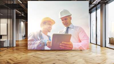 happy builders in hardhats with tablet pc outdoors Wall mural