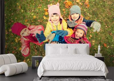 happy children waving hands in autumn park Wall mural