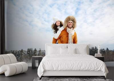 happy couple having fun over winter background Wall mural