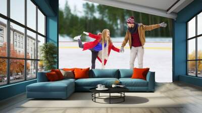 happy couple holding hands on skating rink Wall mural