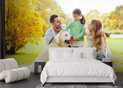 happy family with labrador retriever dog in park Wall mural