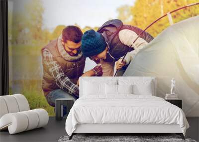 happy father and son setting up tent outdoors Wall mural