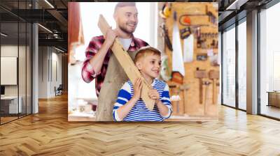 happy father and son with wood plank at workshop Wall mural