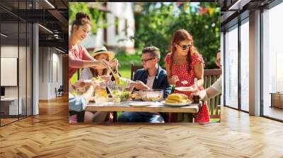 happy friends having dinner at summer garden party Wall mural