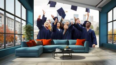 happy graduates or students throwing mortar boards Wall mural