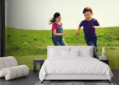 happy little boy and girl running outdoors Wall mural