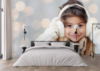 happy little girl in earmuffs over holidays lights Wall mural