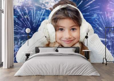 happy little girl wearing earmuffs over firework Wall mural