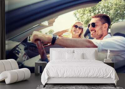 happy man and woman driving in cabriolet car Wall mural