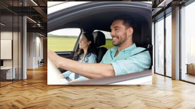 happy man and woman driving in car Wall mural