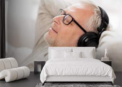 happy man in headphones listening to music at home Wall mural