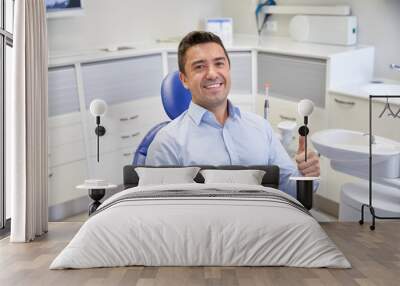 happy man showing thumbs up at dental clinic Wall mural