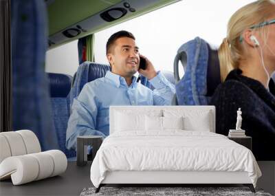 happy man with smartphone and laptop in travel bus Wall mural