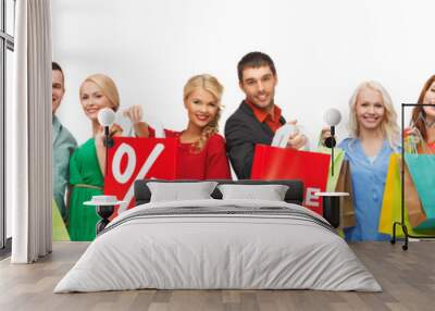 happy people with sale sign on shopping bags Wall mural