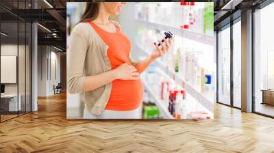 happy pregnant woman with medication at pharmacy Wall mural