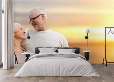 happy senior couple over sunset background Wall mural