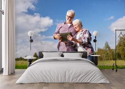 happy senior couple with tablet pc at summer farm Wall mural