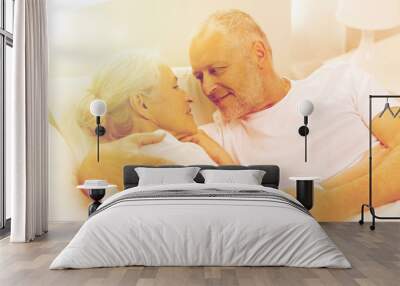 happy senior coupler lying in bad at home Wall mural