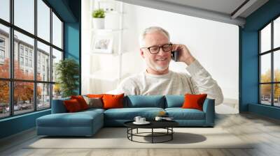 happy senior man calling on smartphone at home Wall mural