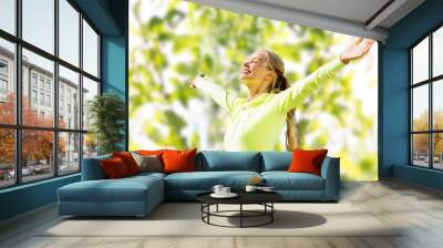 happy woman in sport clothes raising hands Wall mural