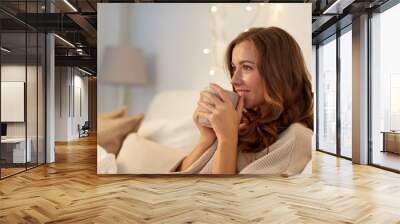 happy woman with cup of coffee in bed at home Wall mural