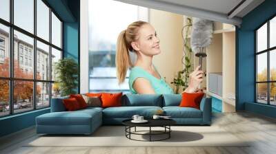 happy woman with duster cleaning at home Wall mural