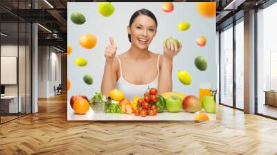 happy woman with healthy food showing thumbs up Wall mural