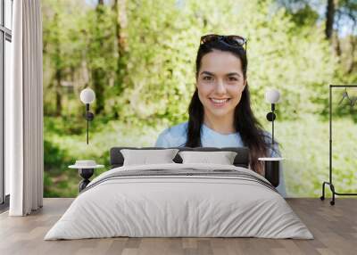 happy young volunteer woman outdoors Wall mural