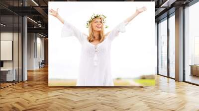 happy young woman in flower wreath on cereal field Wall mural