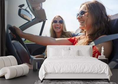 happy young women driving in cabriolet car Wall mural