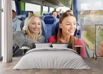 happy young women riding in travel bus Wall mural