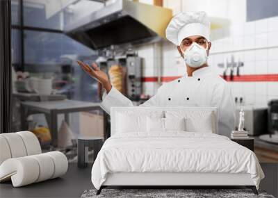 health protection, safety and pandemic concept - indian male chef cook wearing face protective mask or respirator over kebab shop kitchen background Wall mural