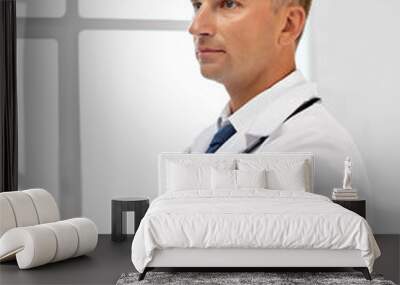 healthcare, medicine and profession concept - smiling male doctor in white coat at hospital Wall mural