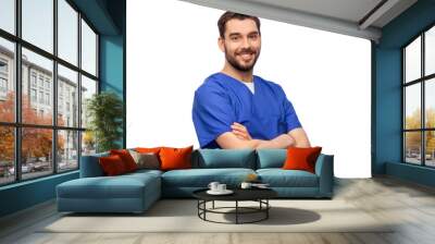 healthcare, profession and medicine concept - happy smiling doctor or male nurse in blue uniform with crossed arms over white background Wall mural