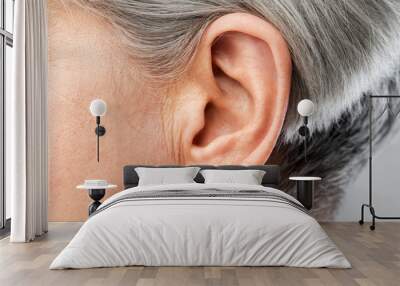 hearing, body part and old age concept - close up of senior woman ear Wall mural