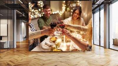 holidays, celebration and people concept - happy friends having christmas dinner at home drinking non-alcoholic red wine Wall mural