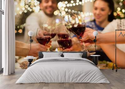 holidays and celebration concept - close up of happy friends having christmas dinner at home, drinking red wine and clinking glasses Wall mural