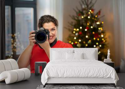 holidays and photography concept - happy woman photographer in red dress with digital camera over grey background Wall mural