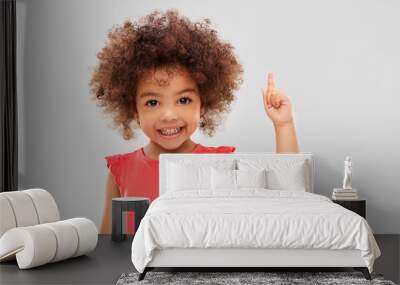 idea, warning and childhood concept - happy little african american girl pointing finger up over grey background Wall mural