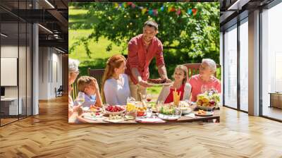 leisure, holidays and people concept - happy family having festive dinner or summer garden party Wall mural