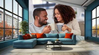 leisure and people concept - happy african american couple drinking coffee or tea at home Wall mural