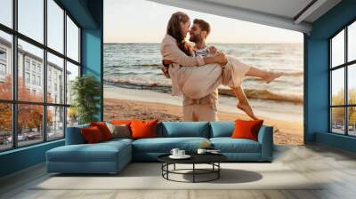 leisure and people concept - happy couple having fun on summer beach Wall mural