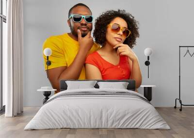 love, relationships and summer concept - african american couple in sunglasses thinking over grey background Wall mural