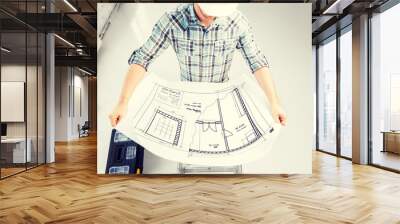 male architect in helmet with blueprint Wall mural