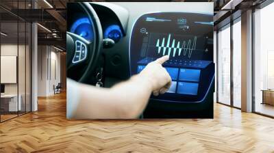 male hand pointing to diagram on screen in car Wall mural