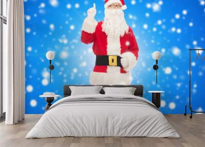 man in costume of santa claus pointing finger up Wall mural