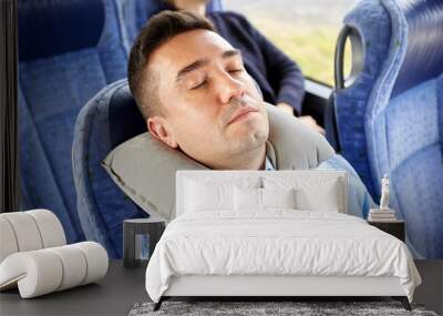 man sleeping in travel bus with cervical pillow Wall mural