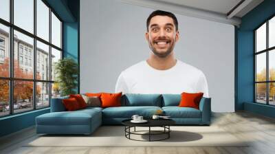 man with funny face over gray background Wall mural