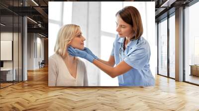 medicine, healthcare and medical exam concept - doctor or nurse checking patient's tonsils at hospital Wall mural